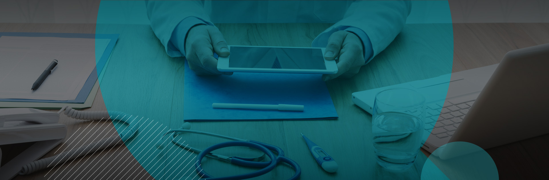 Person holding a phone horizontally with a stethoscope and thermometer on the table. 