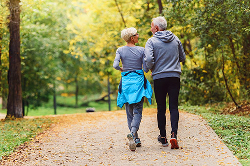 two people walking away from camera next to each other