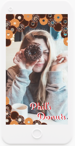 phone with image on screen of someone holding a donut over their eye with the words "Phil's Donut"
