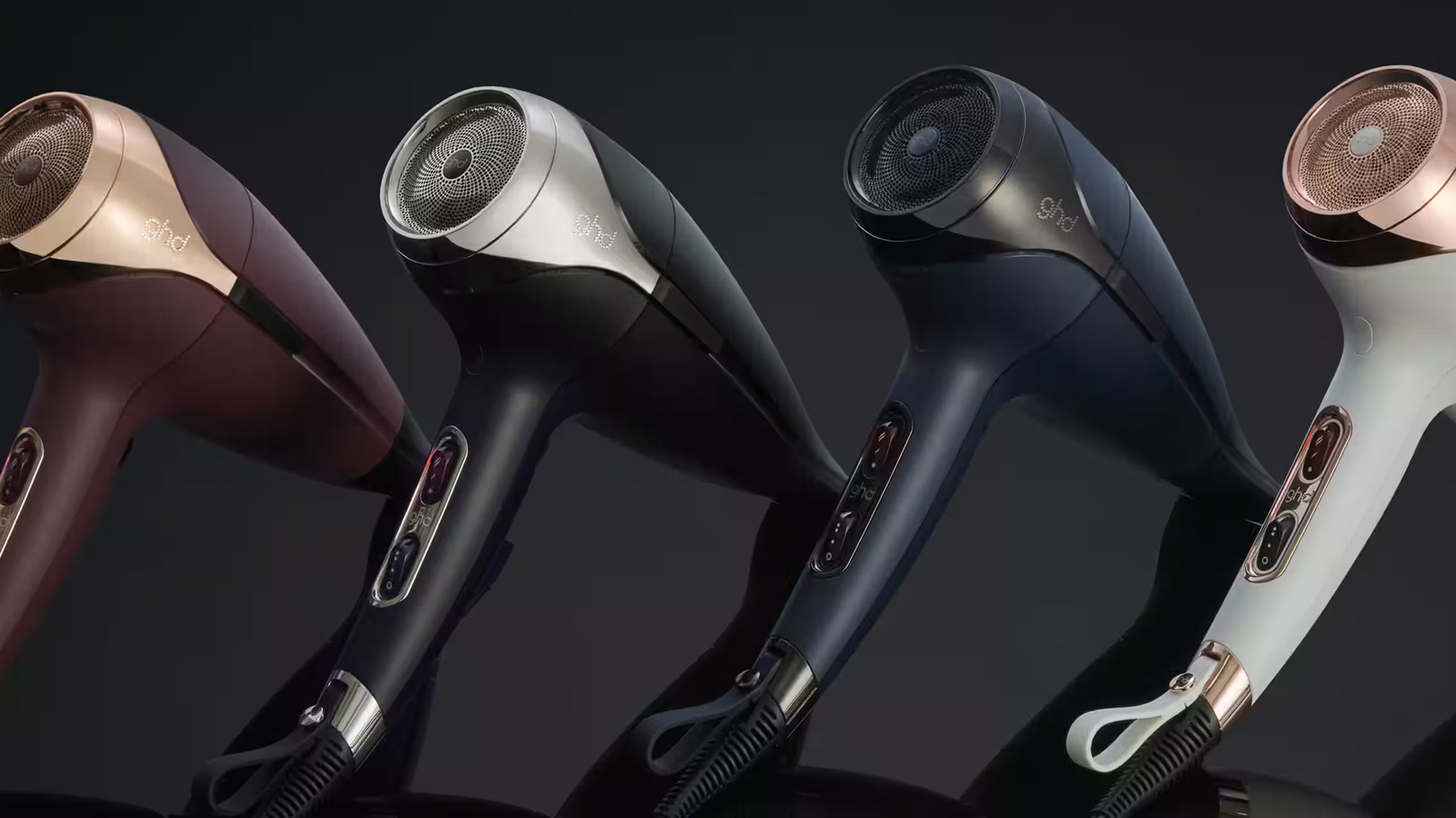 Range of ghd hair driers against a black background