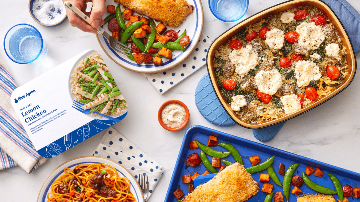 Blue Apron recipe next to various plates, pans, and baking sheets with food.