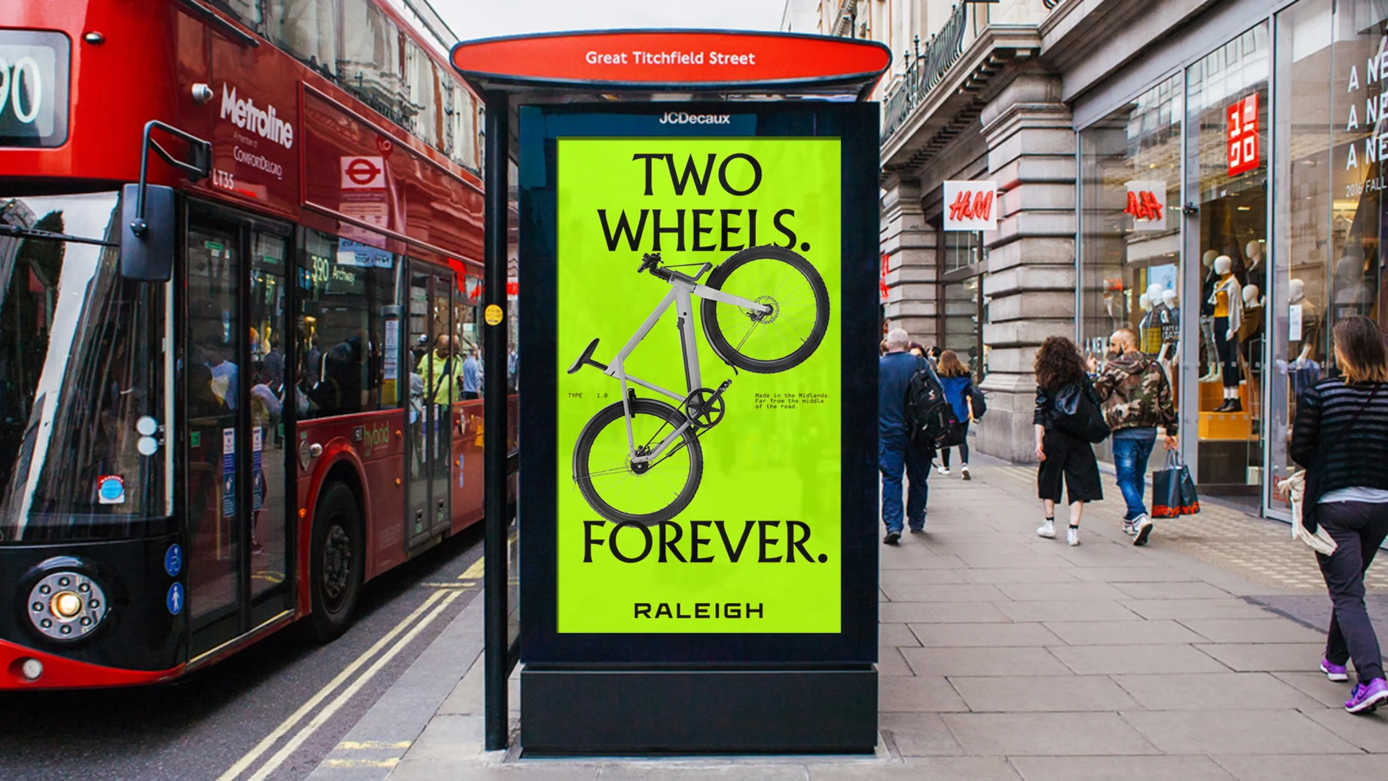 Bus shelter advertisement for Raleigh bikes reading "TWO WHEELS. FOREVER."